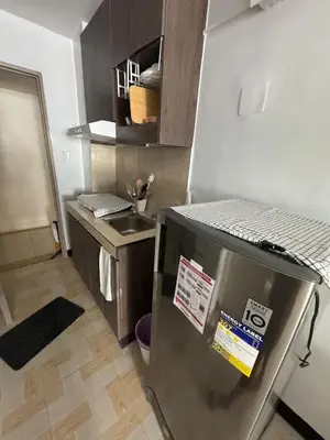 a kitchen with a stainless steel refrigerator and a sink at Overnight sleeps in Manila