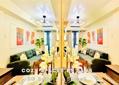 a living room with couches and a table at SM MOA Near NAIA Airports 1 Bedroom with balcony SG Suite 2 at Shore 3 in Manila