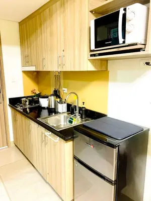 a kitchen with a sink and a microwave at R Cabin - Shore Residences in Manila