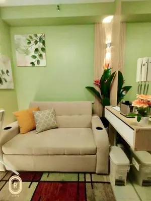 a living room with a couch and a table at R Cabin - Shore Residences in Manila