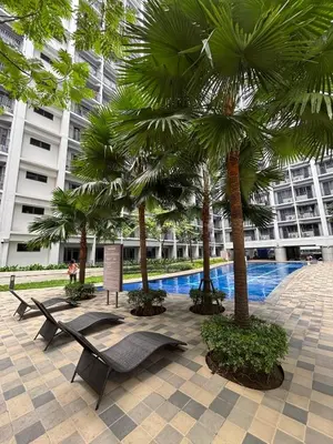 a resort with palm trees and a swimming pool at R Cabin - Shore Residences in Manila