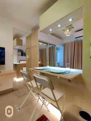 a kitchen with a glass table and two chairs at R Cabin - Shore Residences in Manila