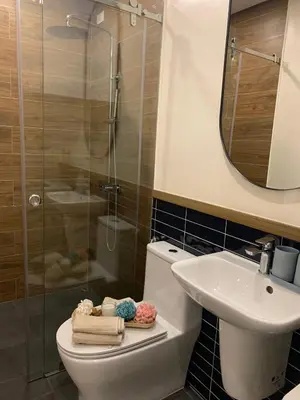 a bathroom with a shower and a toilet and a sink at Vacation in Cupang Muntinlupa in Manila