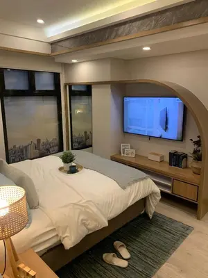 a bedroom with a large bed and a flat screen tv at Vacation in Cupang Muntinlupa in Manila