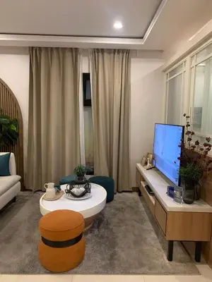 a living room with a couch and a tv at Vacation in Cupang Muntinlupa in Manila