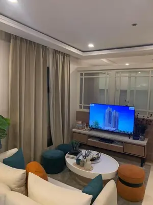 a living room with a tv and a couch and chairs at Vacation in Cupang Muntinlupa in Manila