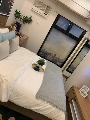 a bedroom with a bed and a large window at Vacation in Cupang Muntinlupa in Manila