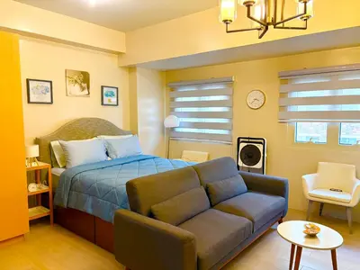 a bedroom with a bed and a couch at Unit 2H 81 Newport Boulevard Condominium Perfect for Layovers Across NAIA Terminal 3 in Manila