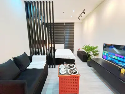 a living room with a couch and a tv at Shore 2 Residences - Takya's Staycation in Manila
