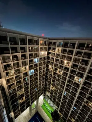 an aerial view of a large apartment building at night at Shore 2 Residences - Takya's Staycation in Manila