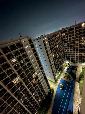 a view of two tall buildings and a swimming pool at Shore 2 Residences - Takya's Staycation in Manila