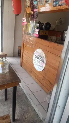 a cat sitting on a counter in a store at Dream hotel in Manila