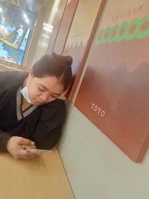 a woman is looking at her cell phone at Dream hotel in Manila