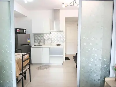 a small kitchen with a sink and a refrigerator at Azure Residences 1 Bedroom with Wide Balcony in Manila