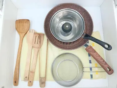 a pot sitting on top of a table with wooden utensils at Azure Residences 1 Bedroom with Wide Balcony in Manila