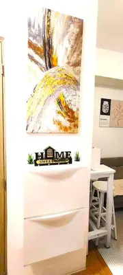 a white desk with a painting on the wall at Move In Condo in Taguig Fully Furnished in Manila