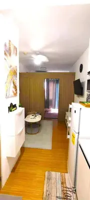 a kitchen with a white refrigerator and a table at Move In Condo in Taguig Fully Furnished in Manila