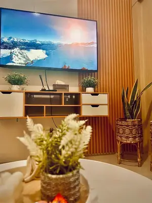 a living room with a large flat screen tv at Sea Residences - Casa Juana at Mall of Asia in Manila