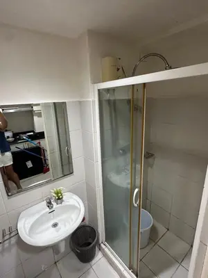 a bathroom with a sink and a shower at Sea Residences - Casa Juana at Mall of Asia in Manila