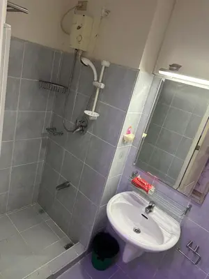 a bathroom with a shower and a sink at Sea Residences - Casa Juana at Mall of Asia in Manila
