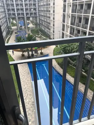 a balcony with a view of a swimming pool at Sea Residences - Casa Juana at Mall of Asia in Manila