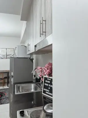 a kitchen with a sink and a refrigerator at Cozy Family and Group-Friendly Private 2 Bedroom with Coffee Bar and Fast Wifi at S Residences Mall of Asia in Manila