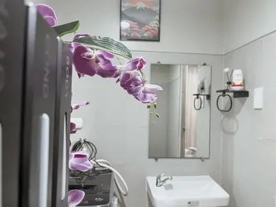 a bathroom with a sink and a purple flower at Cozy Family and Group-Friendly Private 2 Bedroom with Coffee Bar and Fast Wifi at S Residences Mall of Asia in Manila