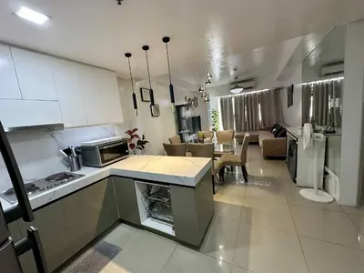 a kitchen and living room with a kitchen and dining room at Shell Residence 2 bedroom by Kathy in Manila
