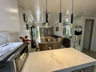a kitchen with a table and a dining room at Shell Residence 2 bedroom by Kathy in Manila