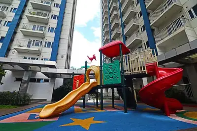 a playground with a slide in front of a building at 1 BR Boni LIGHT Condo WIFI Netflix Pool Balcony in Manila