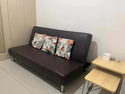 a black couch with a pillow on it in a room at 1 BR Boni LIGHT Condo WIFI Netflix Pool Balcony in Manila