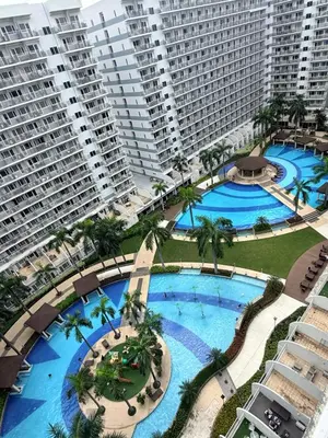 an overhead view of two large pools in a resort at The Nox Suites in Manila