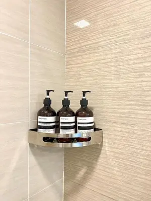 three bottles of paint sitting on a shelf on a wall at La Venezia Executive Home, 3 Bedroom, 7 adults Maximum plus Kids in Manila