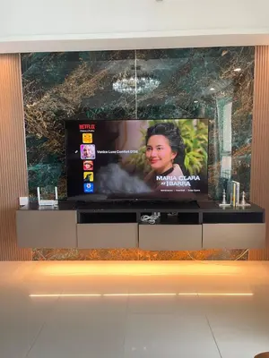 a flat screen tv sitting on top of a entertainment center at La Venezia Executive Home, 3 Bedroom, 7 adults Maximum plus Kids in Manila