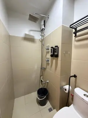a bathroom with a toilet and a shower at Near NAIA Mediterranean Cozy Home with Netflix in Manila
