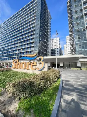 a large building with a sign in front of it at Near NAIA Mediterranean Cozy Home with Netflix in Manila
