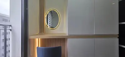 a room with a mirror and a blue chair at Executive Saver Suite 1BR Mall of Asia Airport in Manila