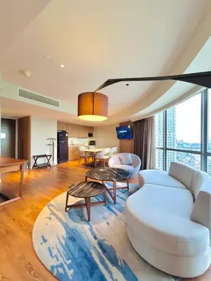 a living room with a white couch and a table at Hotel Residences - Novotel Suites Manila at Acqua in Manila