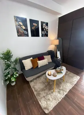 a living room with a couch and a table at Air Residences 28F Balcony WiFi Netflix in Manila