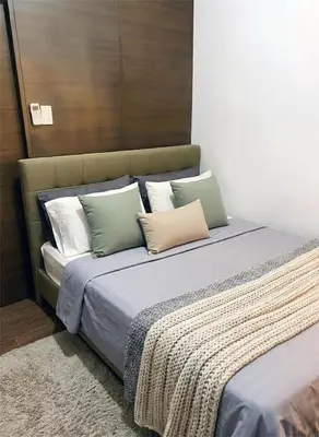 a bed with several pillows on it in a room at Air Residences 28F Balcony WiFi Netflix in Manila