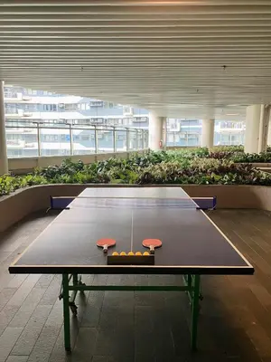 a ping pong table in the middle of a building at Air Residences 28F Balcony WiFi Netflix in Manila