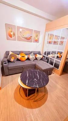 a living room with a couch and a table at Condotels SMB West Road in Manila