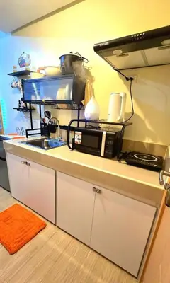 a kitchen with a microwave and a sink at Condotels SMB West Road in Manila