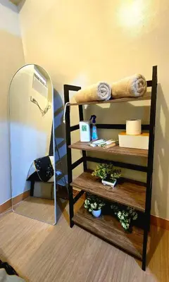 a mirror sitting next to a shelf in a room at Condotels SMB West Road in Manila