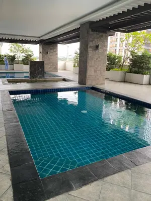 a swimming pool with blue water in a building at EDSA Heights Unit 3405 Cozy One Bedroom Penthouse Unit in Manila