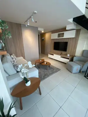 a living room with a couch and a tv at EDSA Heights Unit 3405 Cozy One Bedroom Penthouse Unit in Manila
