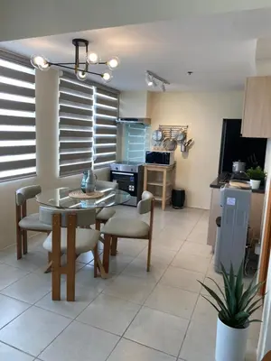 a kitchen and dining room with a table and chairs at EDSA Heights Unit 3405 Cozy One Bedroom Penthouse Unit in Manila