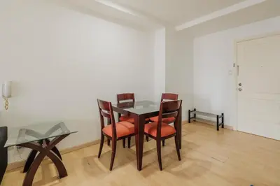 a dining room with a table and four chairs at Free Parking at Gramercy with Big TV and Fast WiFi in Manila