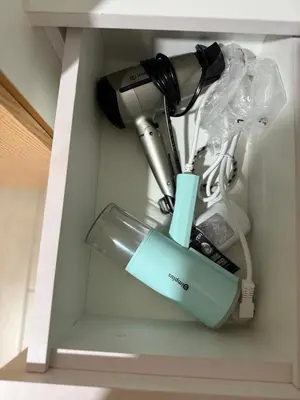 a hair dryer in a shelf with a hair dryer at One Uptown Residences, BGC, Taguig in Manila