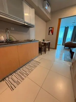 a kitchen with a sink and a counter top at One Bedroom with Netflix at Uptown Residences, BGC, Taguig in Manila